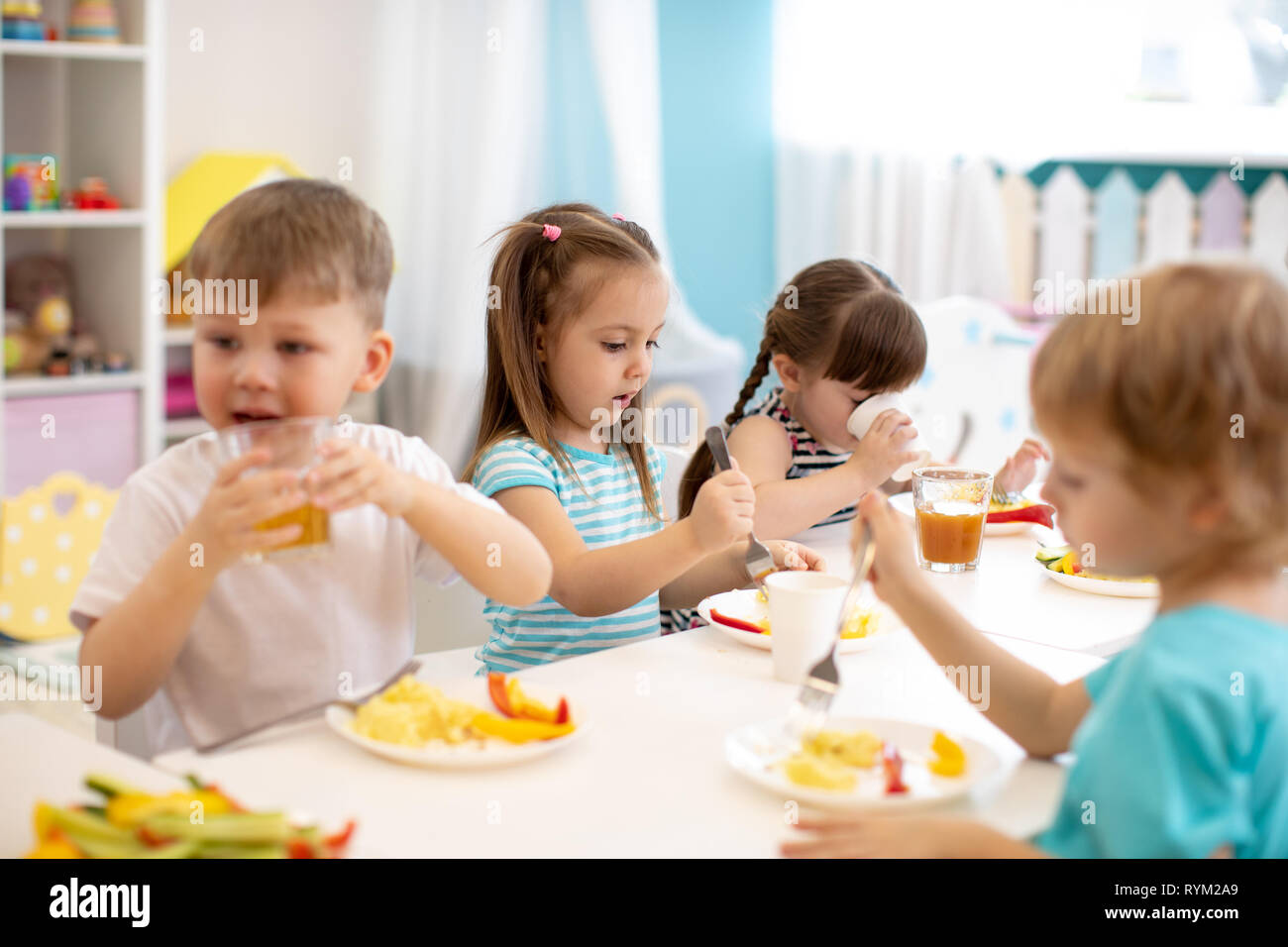 Children eating at the canteen Stock Photo by ©Wavebreakmedia 108970516