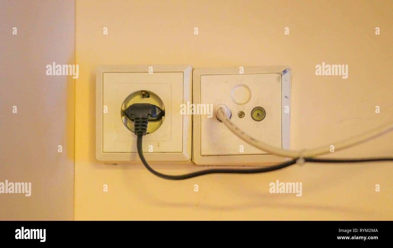 Closer look of the sockets and wires on the wall inside the bedroom