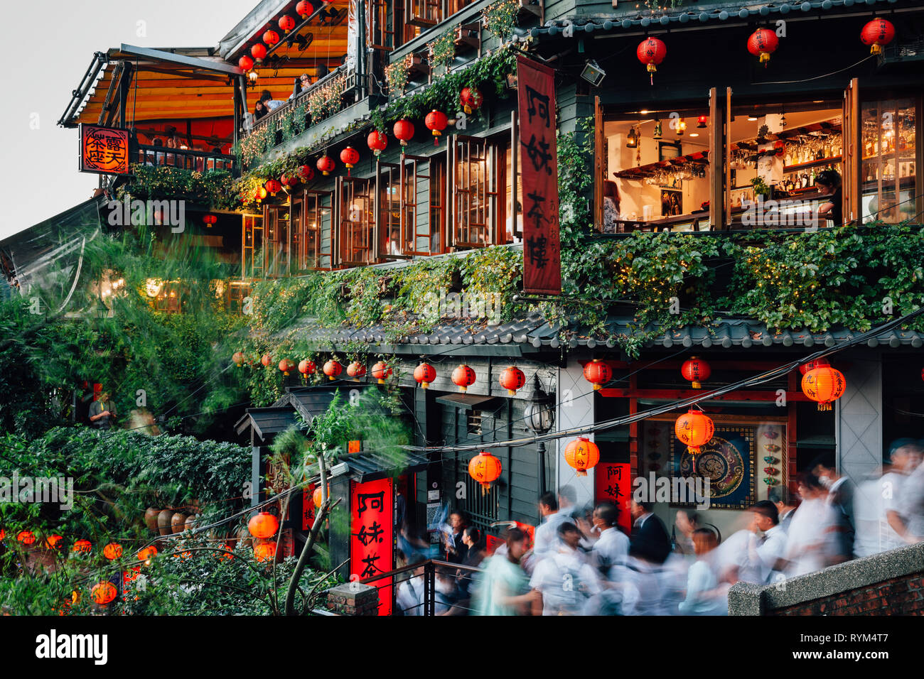Jiufen, Taiwan - November 7, 2018: Tourists walk through the famous stair in front of the old teahouse decorated with Chinese lanterns, Jiufen Old Str Stock Photo