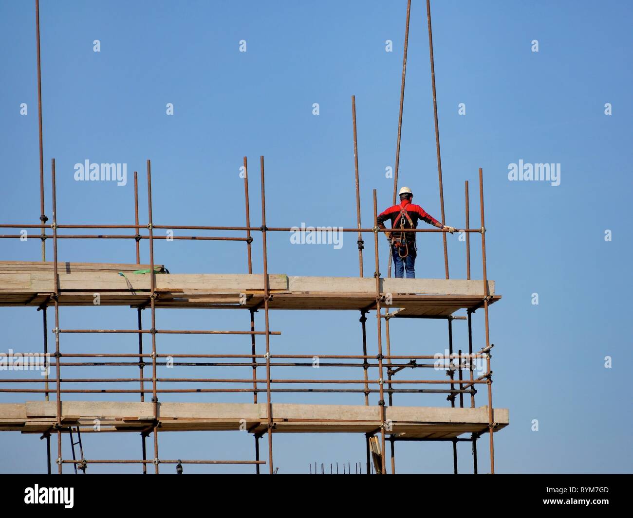 Unrecognizable construction worker on construction site scaffolding Stock Photo