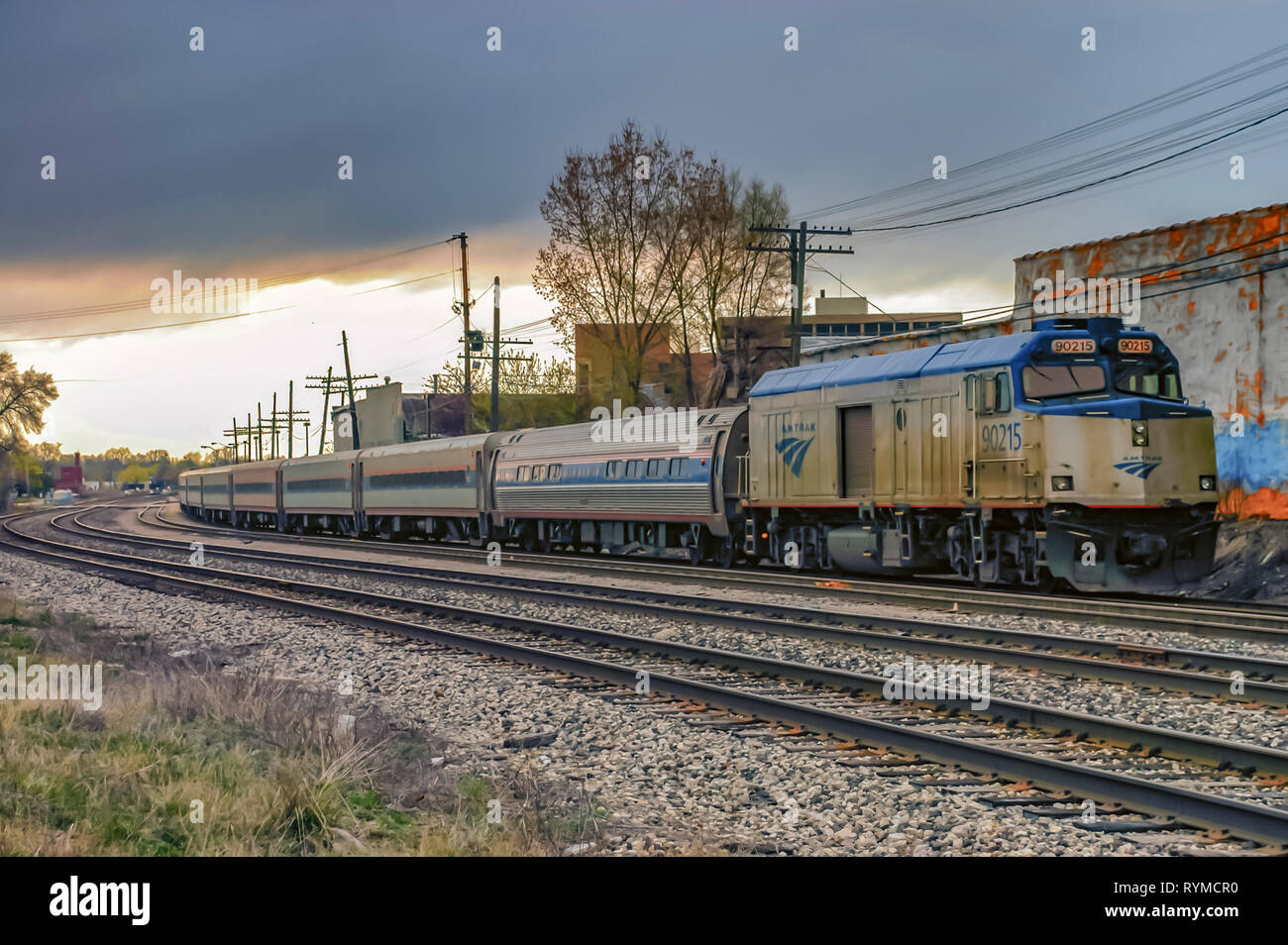 A stationary Amtrak train-National Railroad Passenger Corporation-idling on the tracks, on an overcast morning, at Pontiac, Michigan, USA. Stock Photo