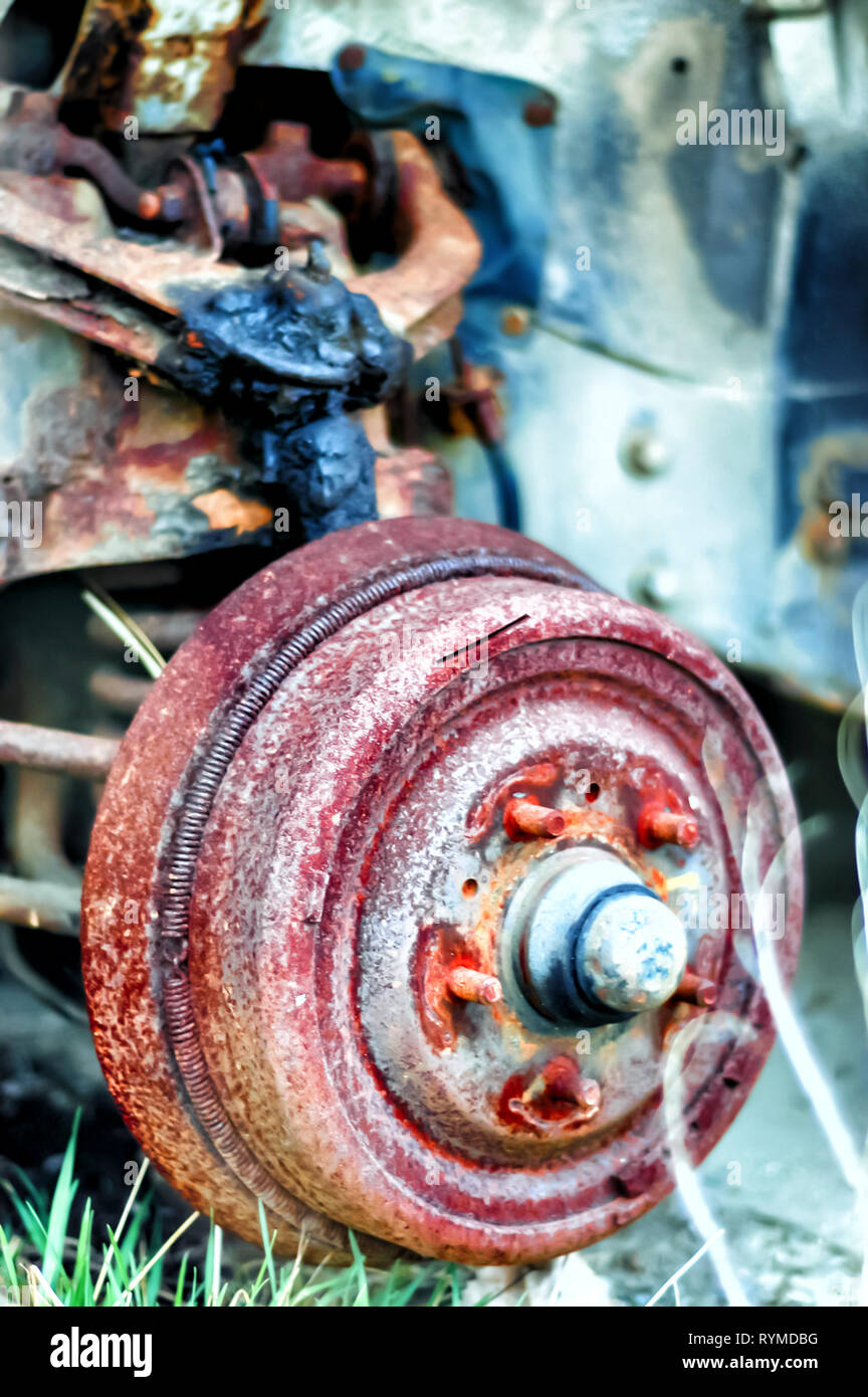 Close up shot of a rusting wheel hub of an abandoned Lincoln