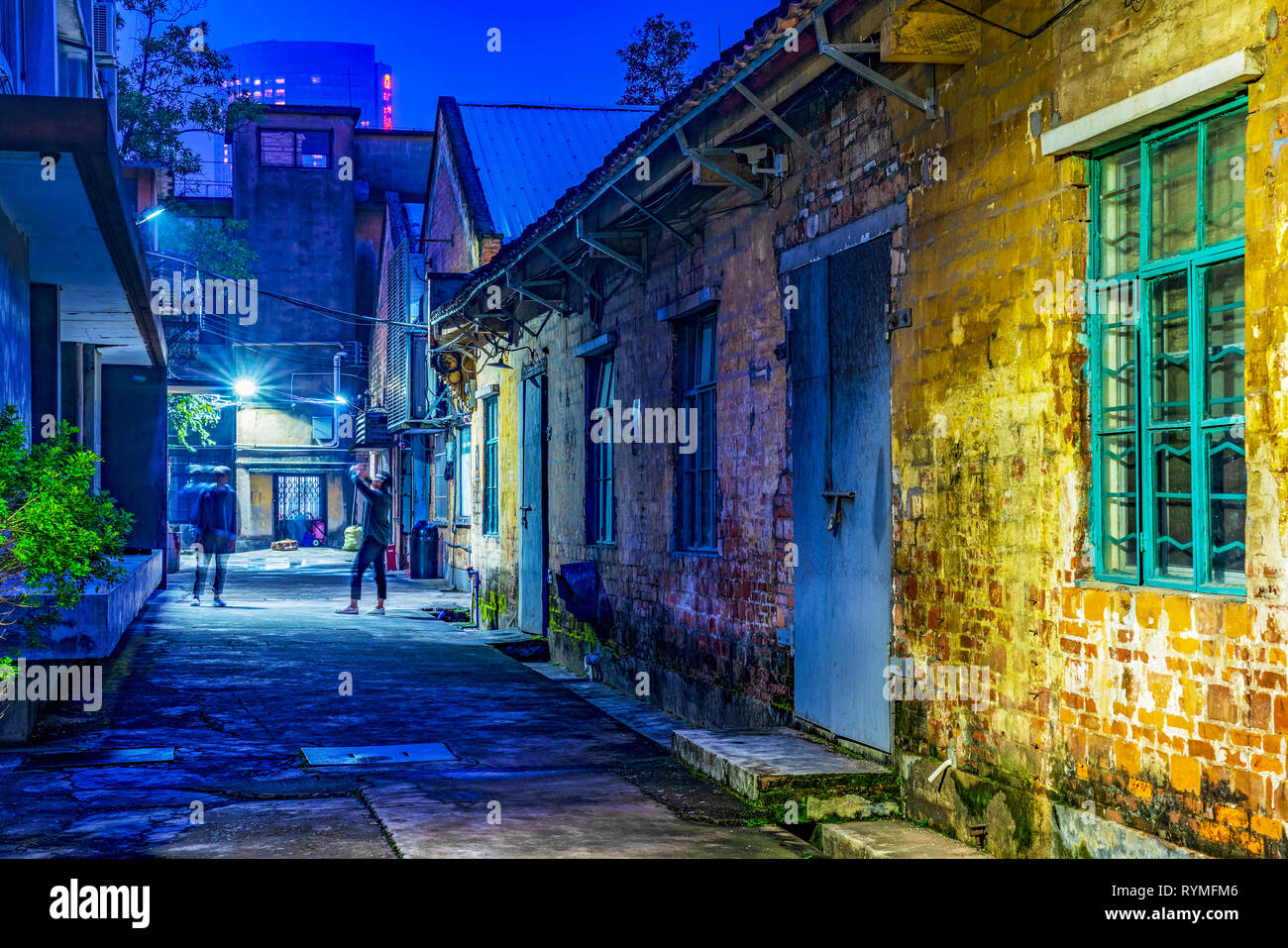 GUANGZHOU, CHINA - OCTOBER 19: This is a night view of an alley with old abandoned warehouse buildings at Redtory Art and Design Factory on October 19 Stock Photo