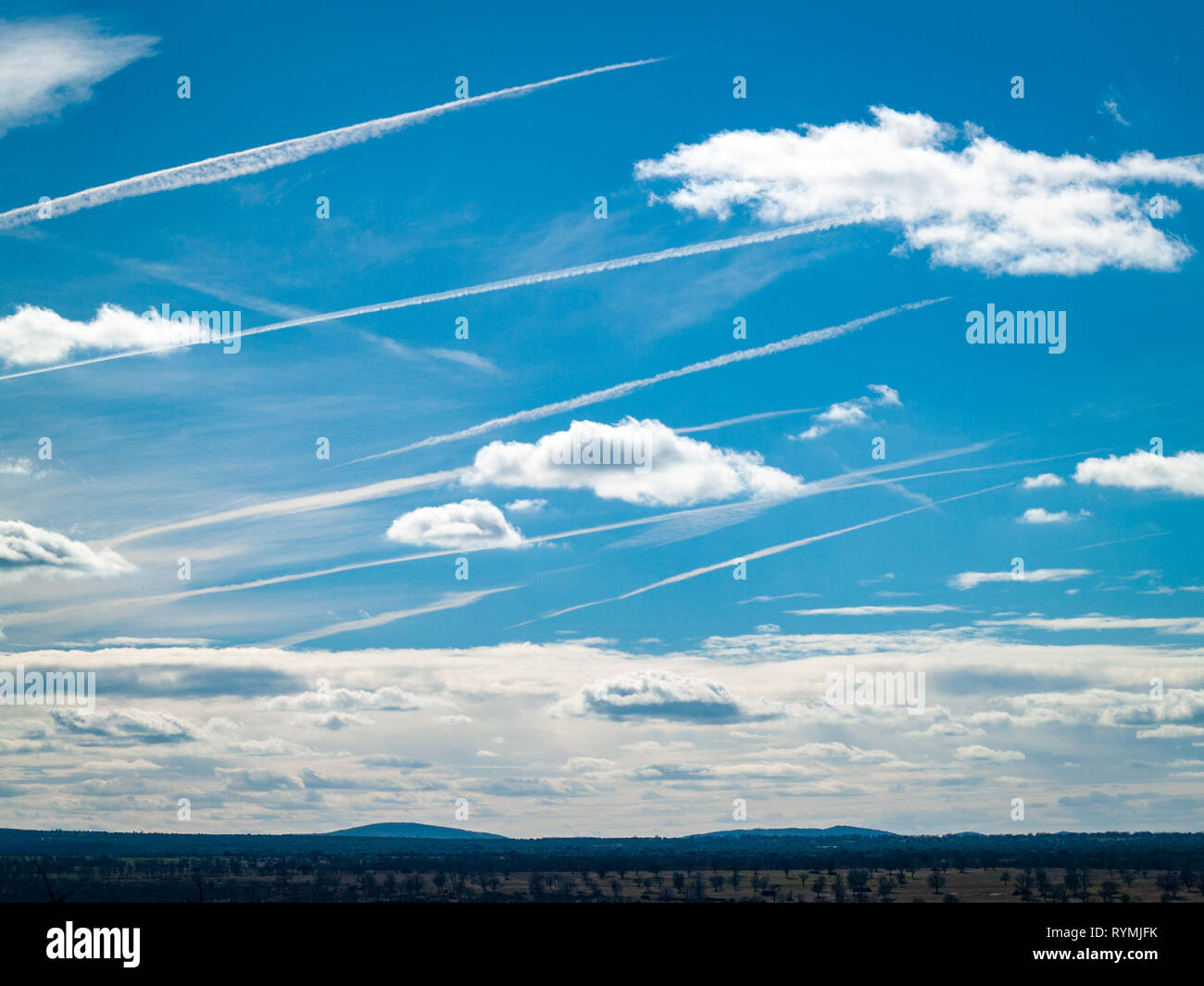 Chemtrails or vapor condensation trails of aircraft in the sky Stock Photo