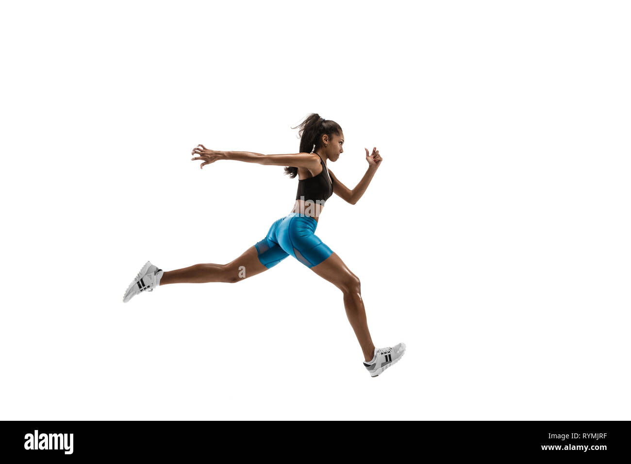 Young african woman running isolated on white studio background. One