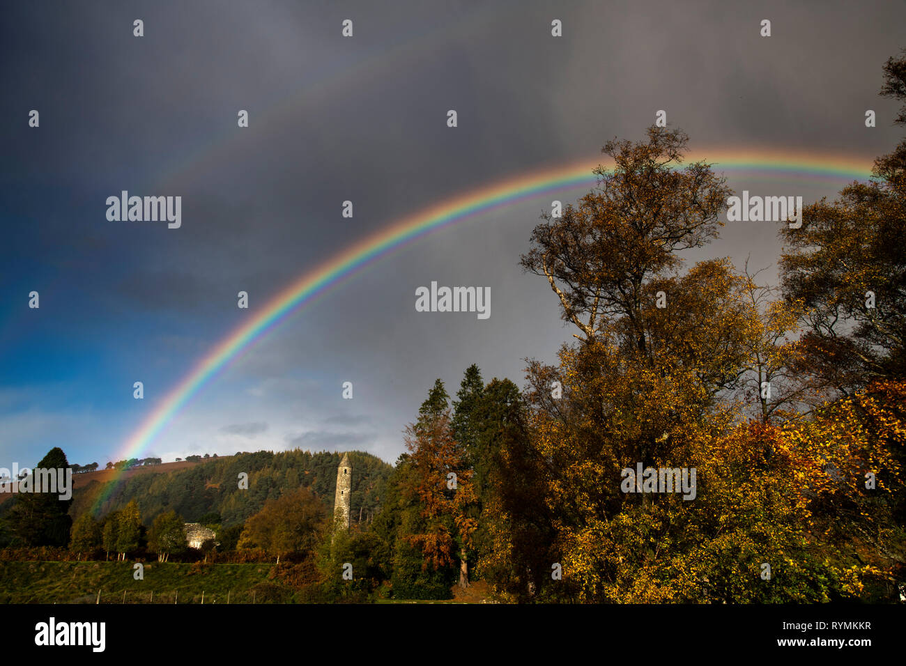 Rainbow at Glendalough over Round Tower county Wicklow Stock Photo