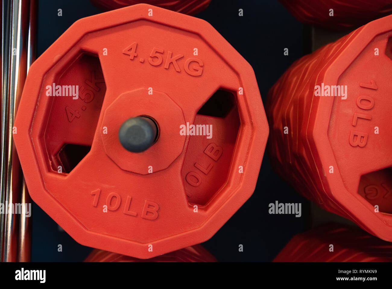 Close up red weight plates in gym close Stock Photo Alamy