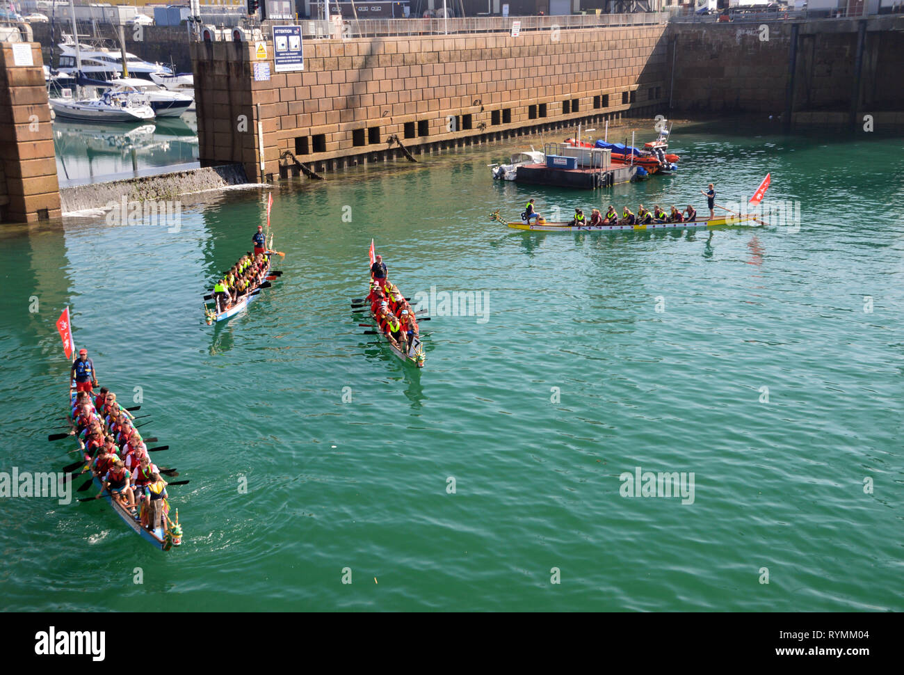 Boat Crews Getting Ready for the Dragon Race in Albert Dock, St Helier, Island of Jersey, Channel Isles, UK. Stock Photo