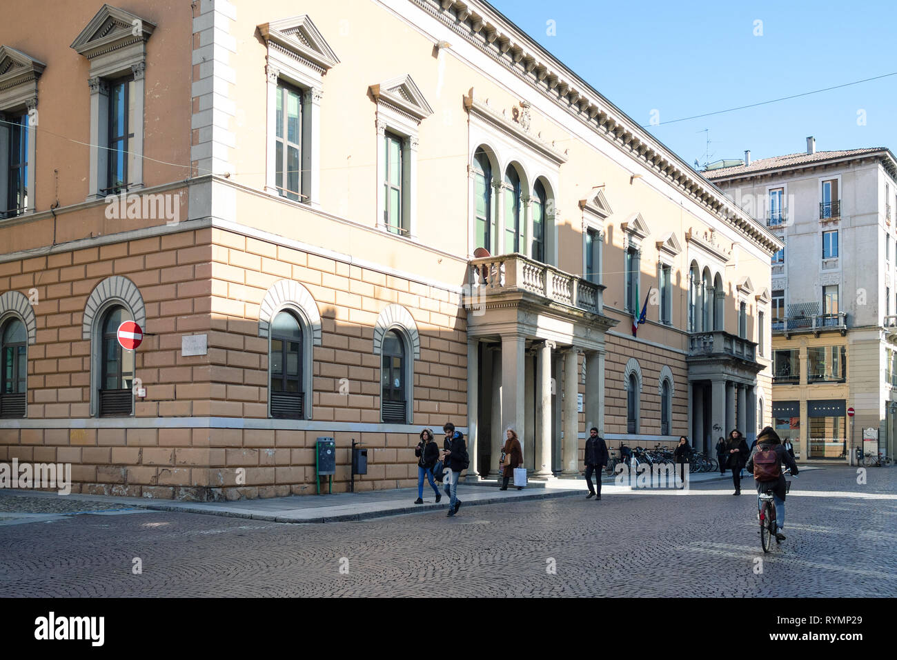 PAVIA, ITALY - FEBRUARY 22, 2019: people walk on street Corso Camillo Benso Cavour near Primary School G Carducci ( Scuola Elementare Statale G Carduc Stock Photo