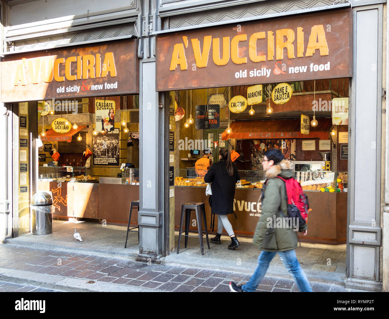 PAVIA, ITALY - FEBRUARY 22, 2019: people walk near street restaurant with sicilian specialties A'Vucciria on street Corso Camillo Benso Cavour in Pavi Stock Photo