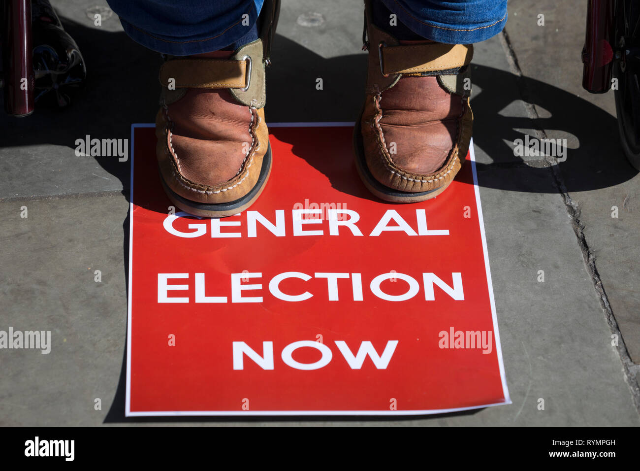 On the day that MPs in Parliament vote on a possible delay on Article 50 on EU Brexit negotiations by Prime Minister Theresa May, an activist demands a general election during a protest outside the House of Commons, on 14th March 2019, in Westminster, London, England. Stock Photo