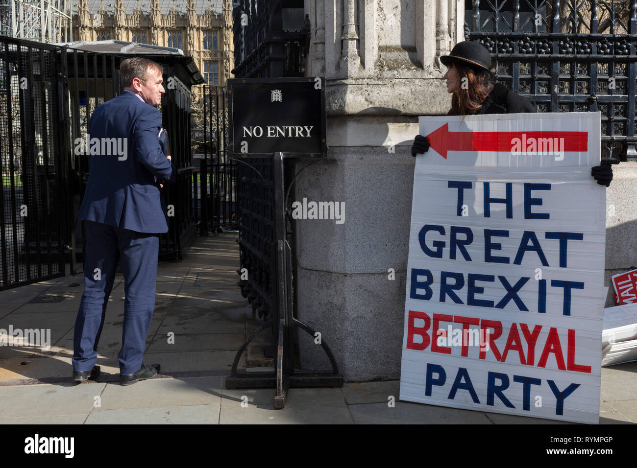 On the day that MPs in Parliament vote on a possible delay on Article 50 on EU Brexit negotiations by Prime Minister Theresa May, George Eustice, MP for Camborne, Redruth & Hayle, exchanges words with Brexiteer activists as they protest at the gates of the House of Commons, on 14th March 2019, in Westminster, London, England. Stock Photo
