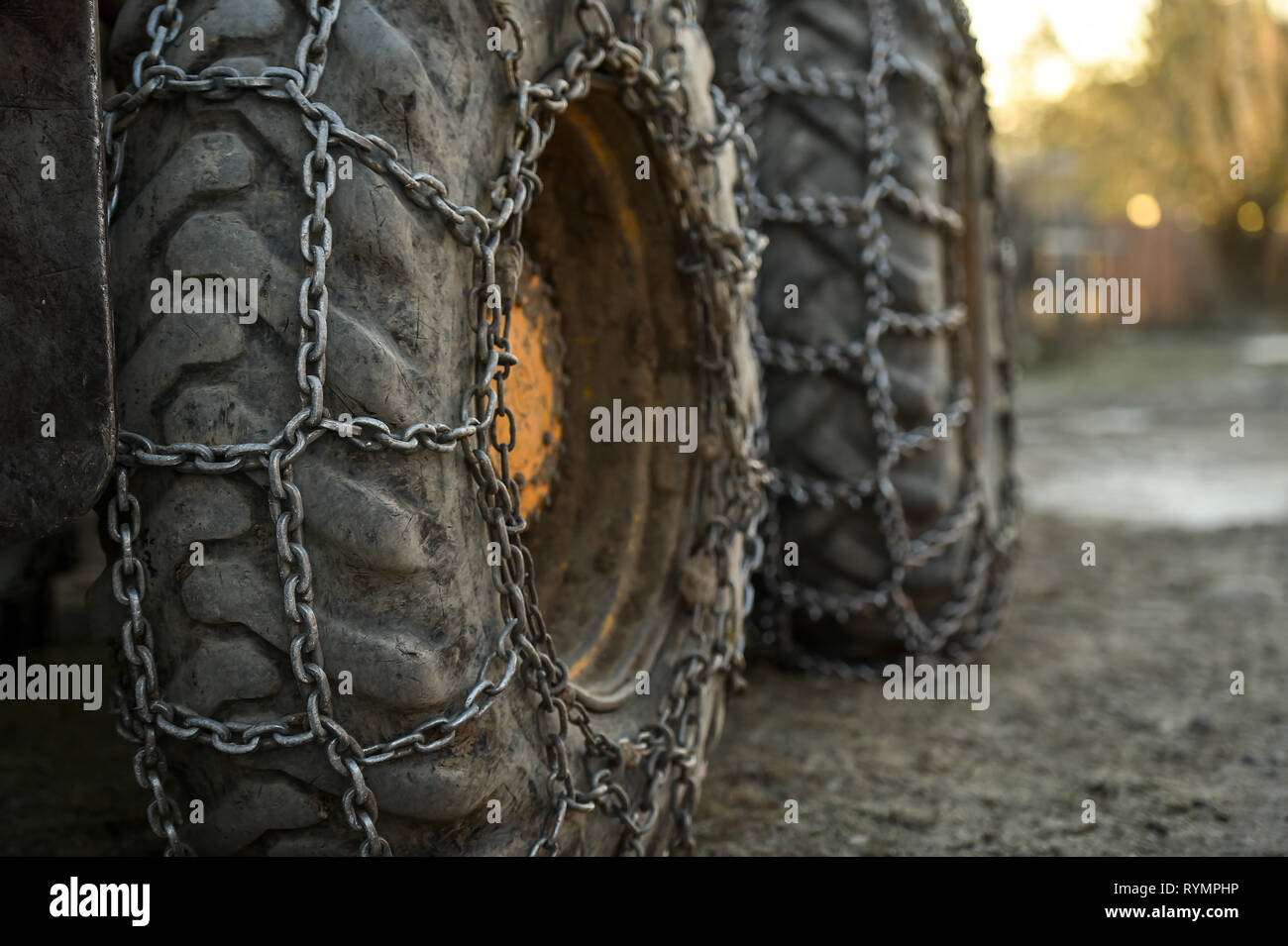 Photo detail with snow tire chains on big truck wheel Stock Photo