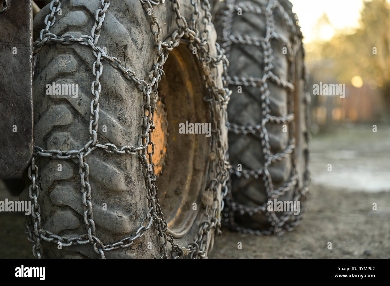 Photo detail with snow tire chains on big truck wheel Stock Photo