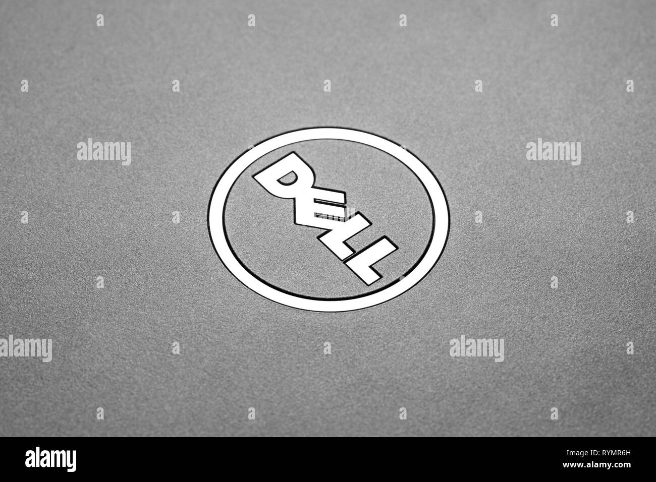 A Dell logo on a silver laptop. Dell is an American technology company based in Texas that makes computer products that are sent worldwide. Stock Photo