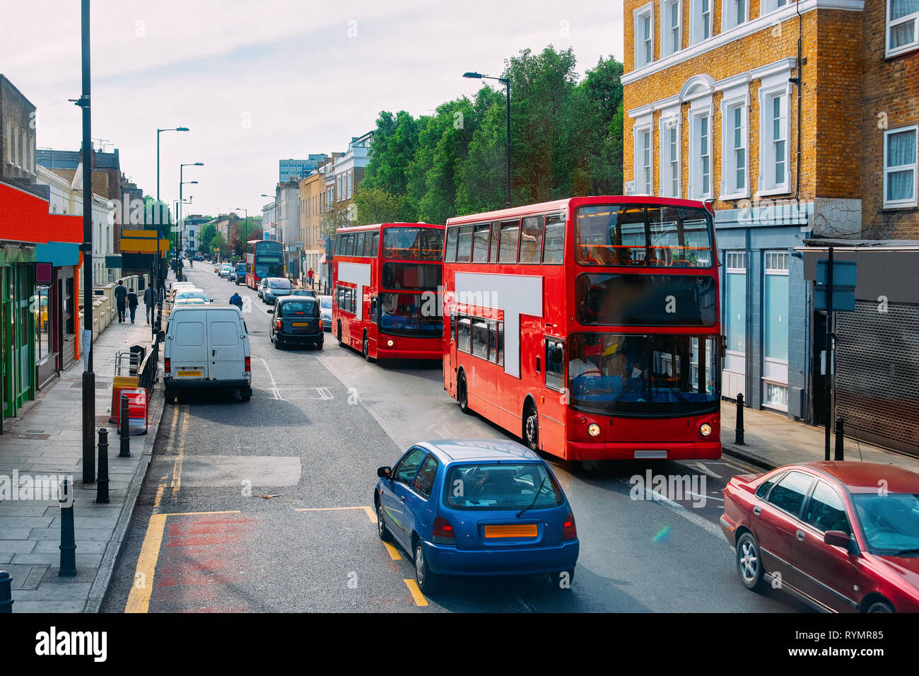 Red double decker bus on road in downtown street in London city in the ...