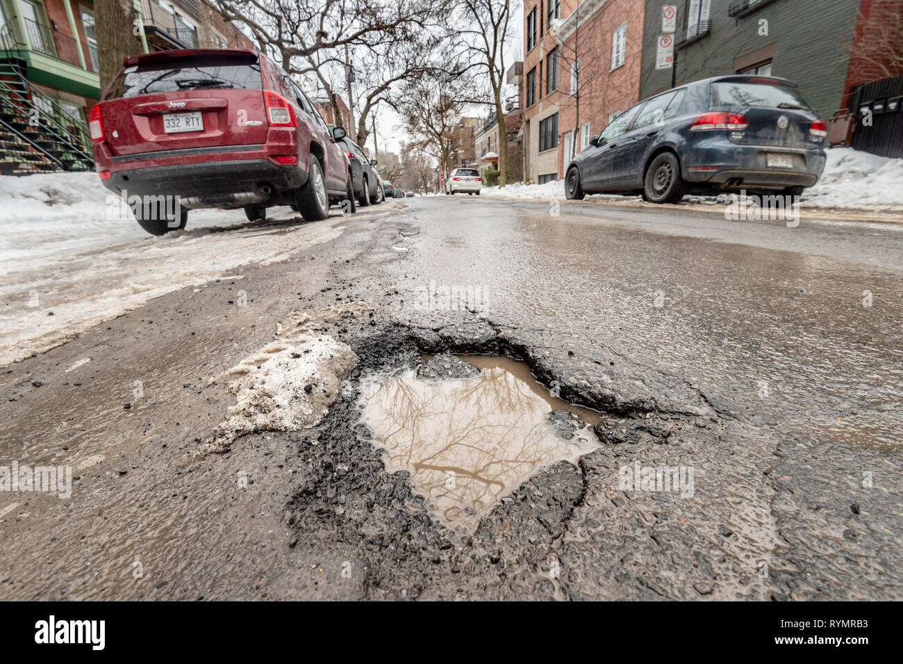 Montreal, CA - 13 March 2019: Large pothole in Montreal street, in Winter Stock Photo