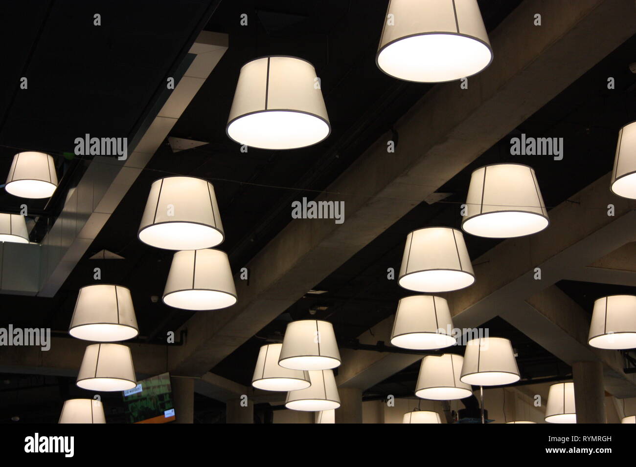 Modern Lamps And Bulbs Hanging From The Ceiling Radiate Light In
