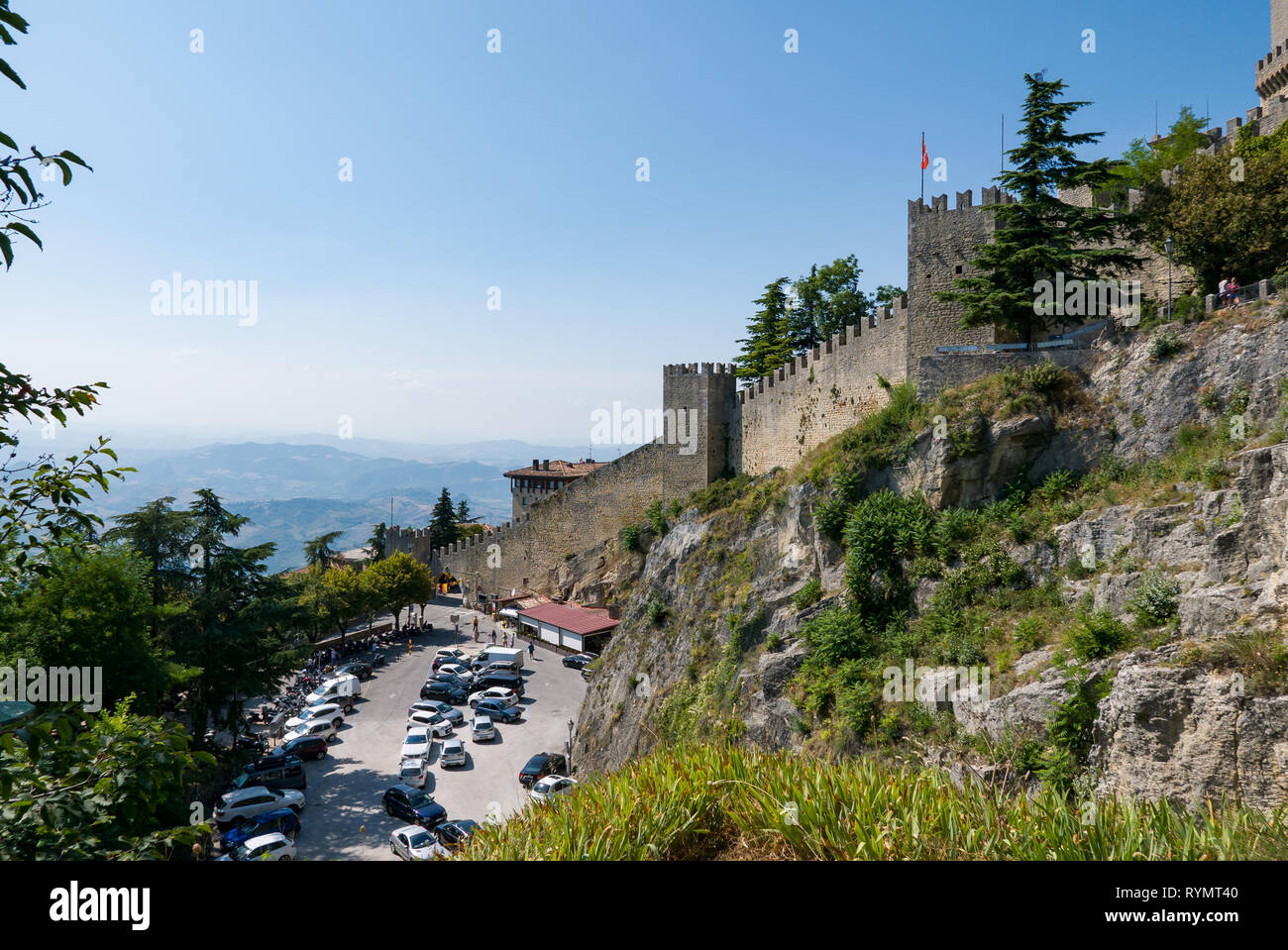 Guaita tower in the fortifications of San Marino on Monte Titano, with the City of San Marino on the left. Stock Photo