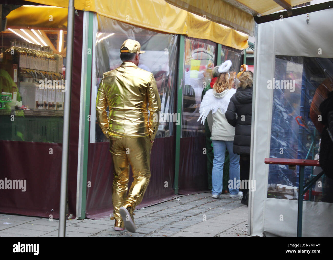 Man, dressed up at carnival as golden boy.  Funny symbolic dress for being highly successful and an above average performer. Stock Photo