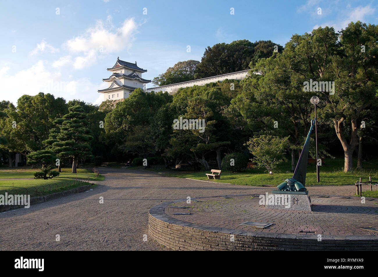 AKASHI, KANSAI, JAPAN - 6th OCTOBER 2018 : View of the Akashi castle and of the surrounding park, with a monument in the foreground in Akashi, Japan Stock Photo