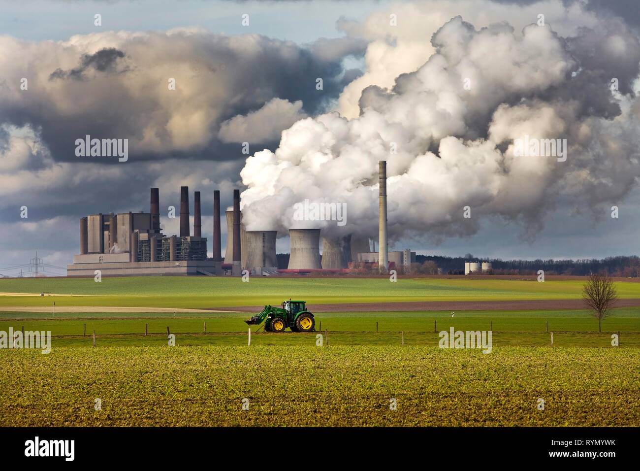 Tractor on a field in front of the steaming lignite-fired power station Frimmersdorf, Grevenbroich Stock Photo