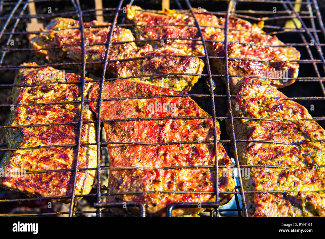 Beef spicy steak in marinade roasted on braai. Barbecue with delicious  beefsteak meat on the grill top view. Outdoor season cooking. Picnic on  vacatio Stock Photo - Alamy