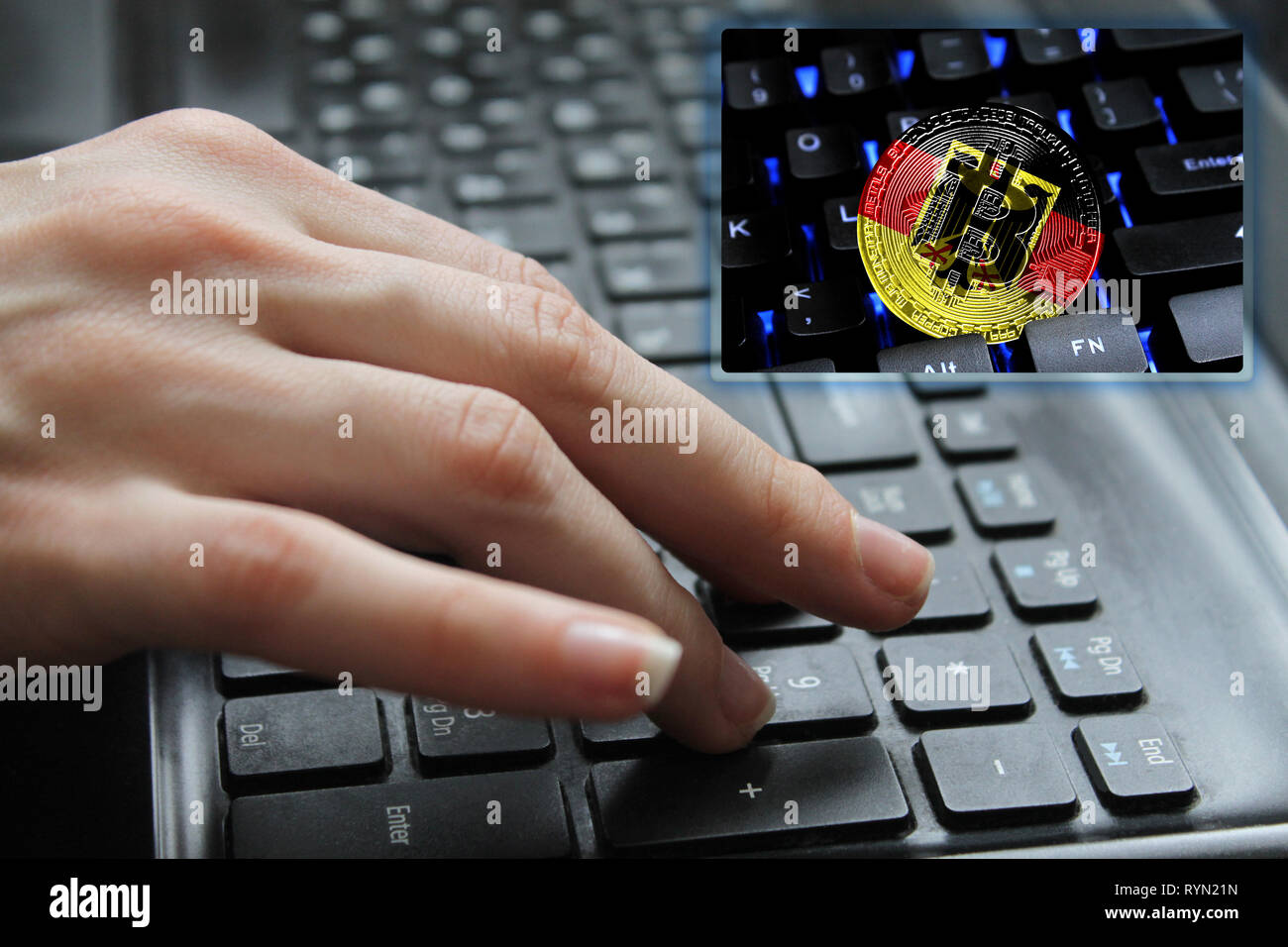 Hand of the girl on the keyboard close up with the concept of digital technology on the purchase and sale of crypto currency bitcoin with a flag of Ge Stock Photo