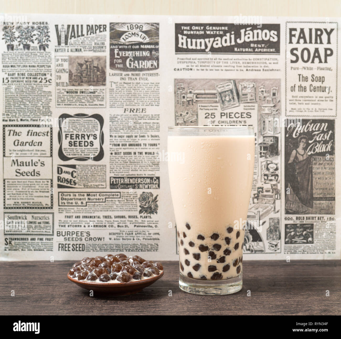 A glass cup of pearl milk tea (also called bubble tea) and a plate of  tapioca ball on white background. Pearl milk tea is the most representative  drin Stock Photo - Alamy