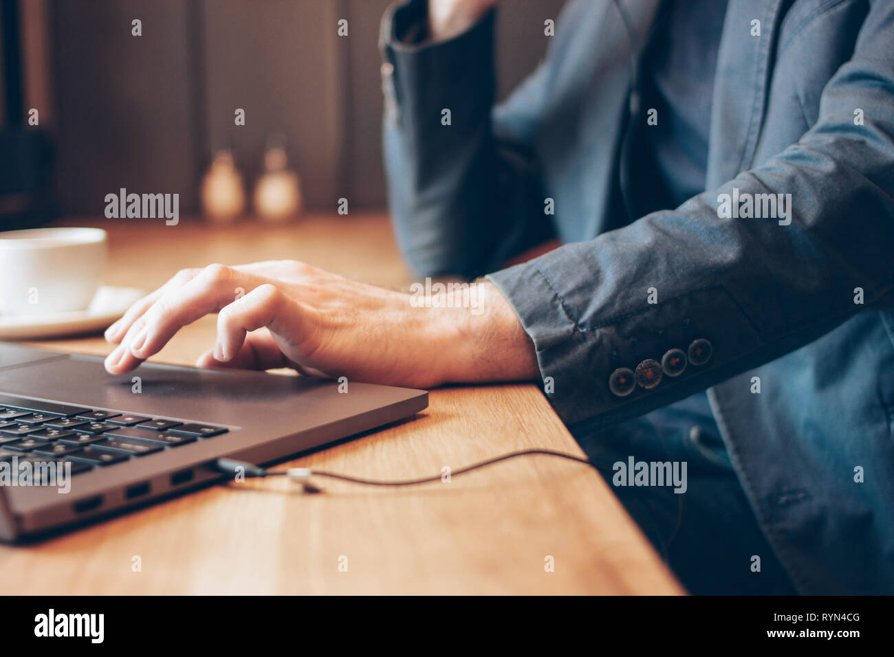 The Man In Blue Suit With Headphones Working On Laptop In Cafe Stock 