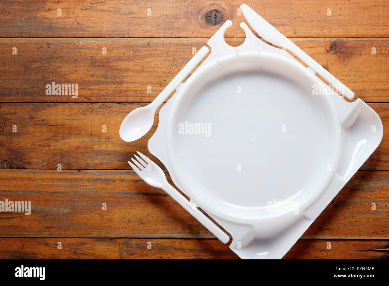 Plastic Plate on Wooden Background Stock Photo