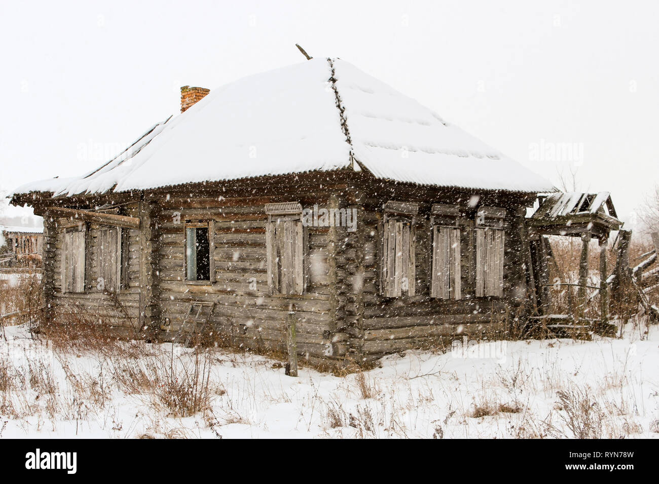 Old abandoned dilapidated wooden house covered with snow Stock Photo ...