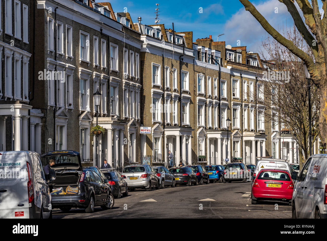 A crescent shaped street of Georgian portico fronted terraced housing in South West London London, London ,UK Stock Photo