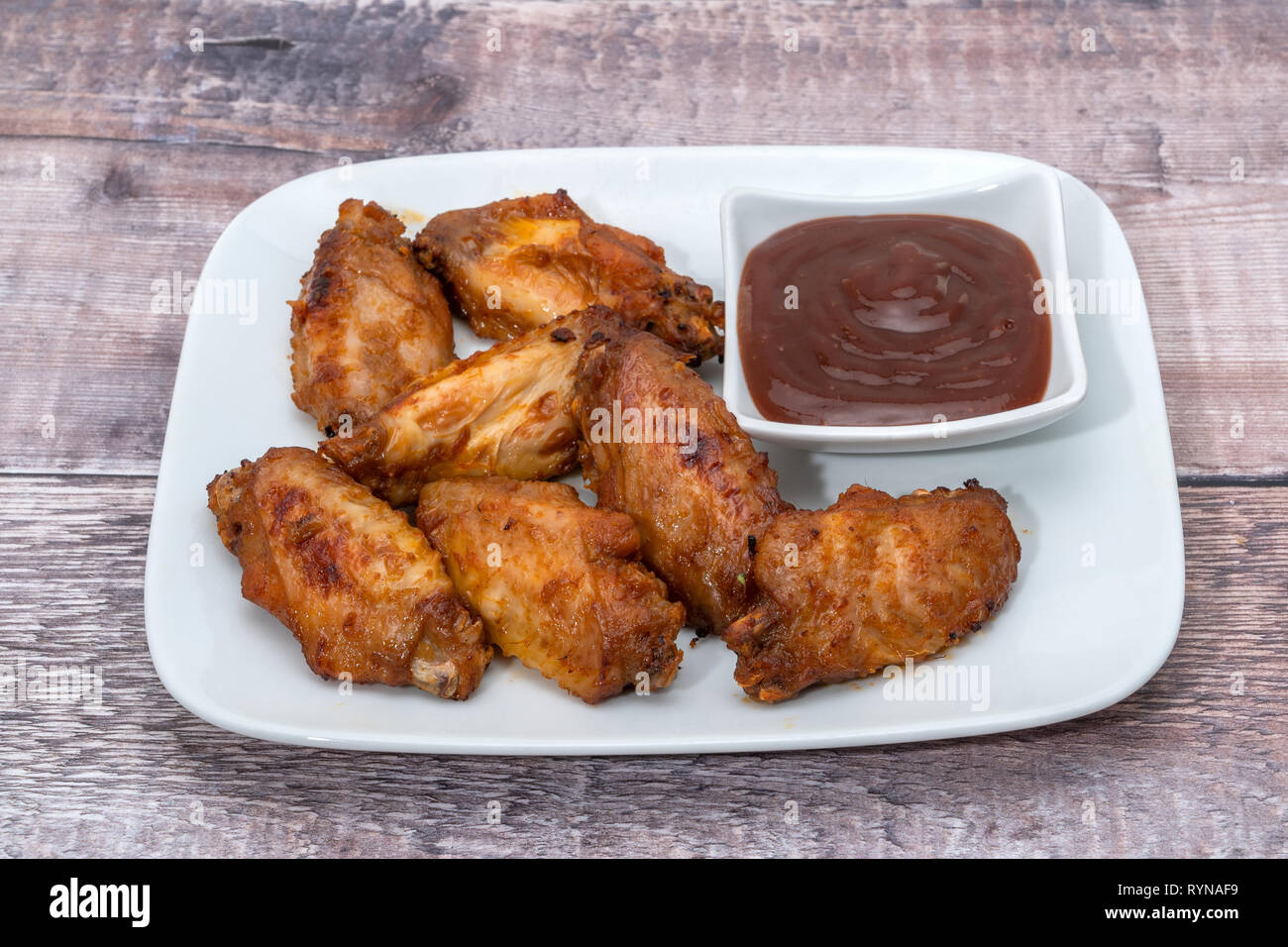 Barbecue chicken wings with a BBQ dip Stock Photo
