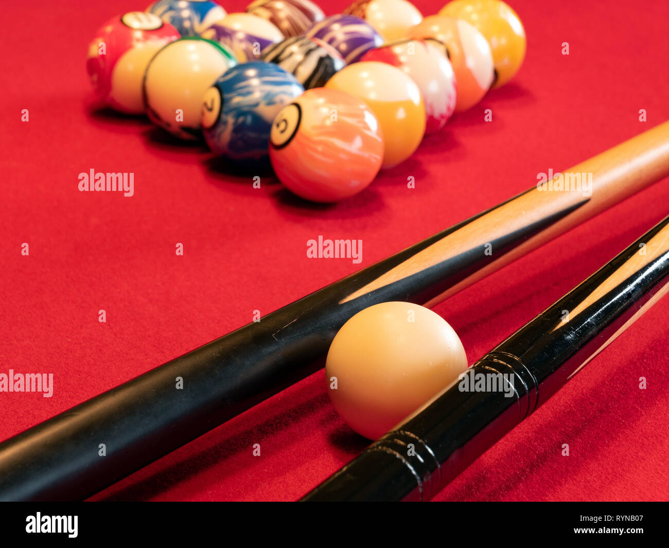 Pool table with cues and balls Stock Photo