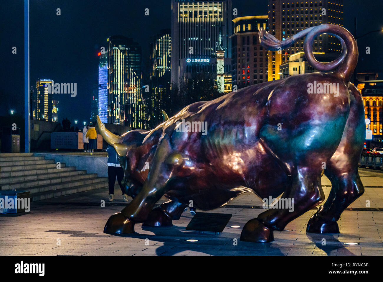 SHANGHAI, CHINA, DECEMBER - 2018 - Urban night scene depicting the famous bull sculpture at bund zone in shanghai city, china Stock Photo