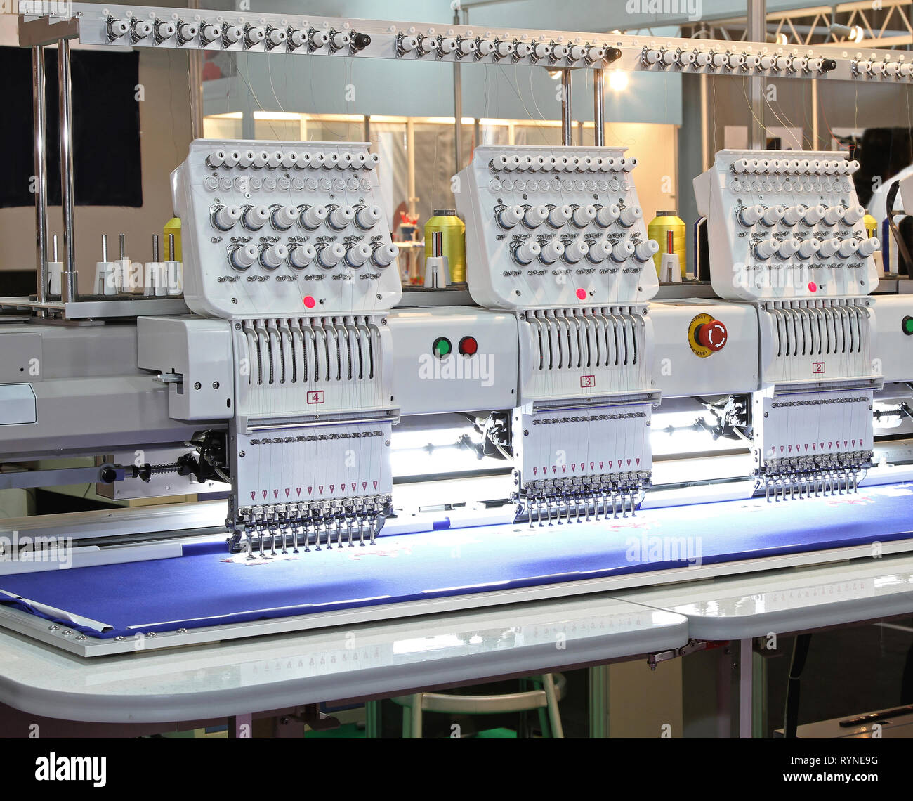 Automated Embroidery Machine in Garment Factory Production Stock Photo