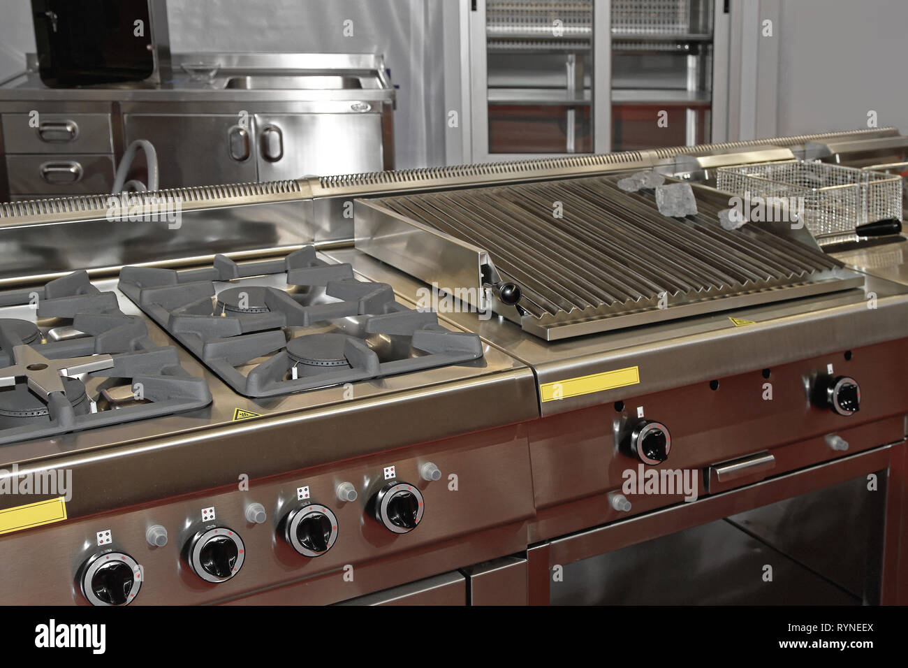 Gas Hob Stove and Grill in Professional Kitchen Restaurant Stock Photo