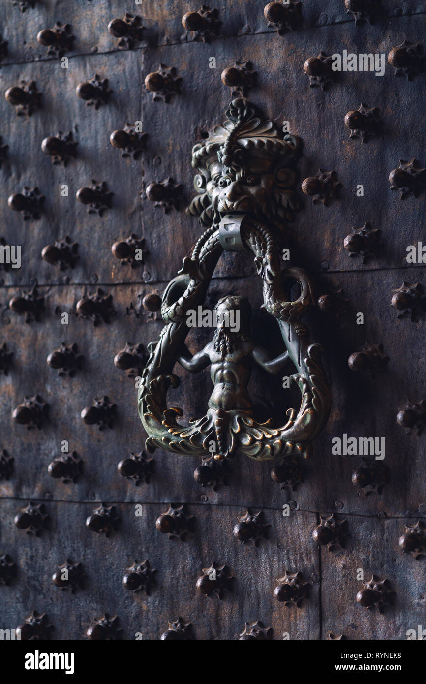 Black metallic Italian style door handle and knocker Stock Photo
