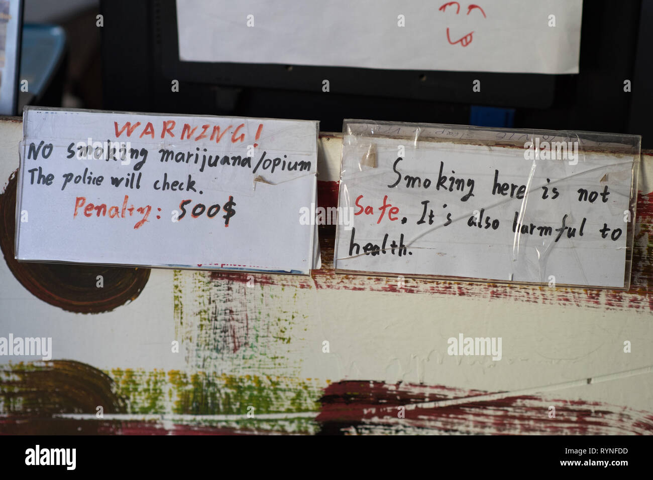 Vang Vieng, Laos - December 28, 2018: a hostel's notes warn smoking marijuana & opium is not allowed in the hostel & unhealthy. Stock Photo