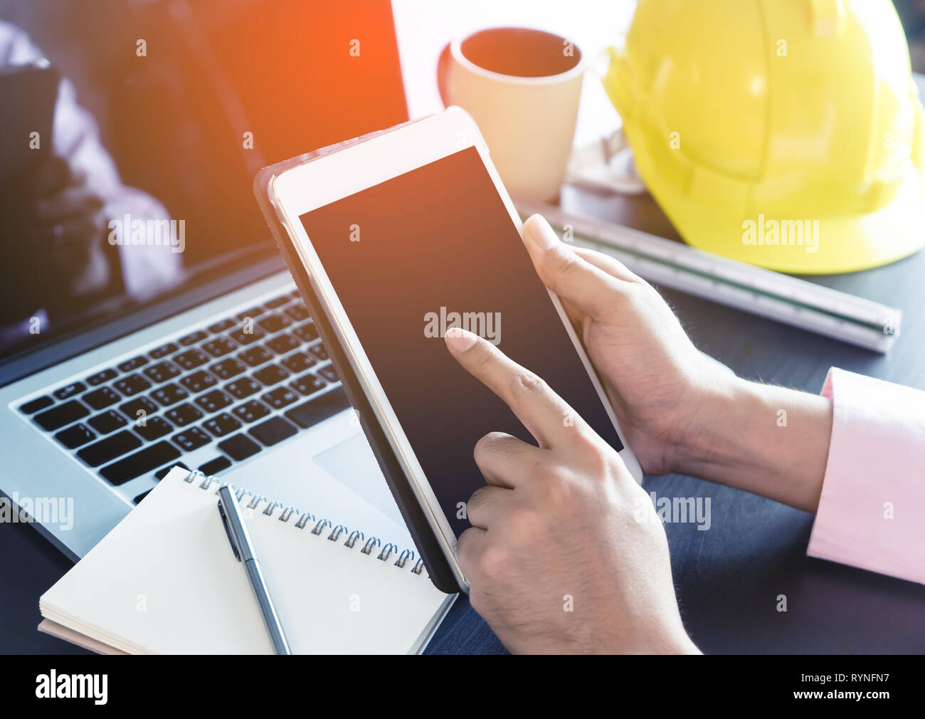 Engineer holding a blank tablet screen for tablet engineering application mock up Stock Photo