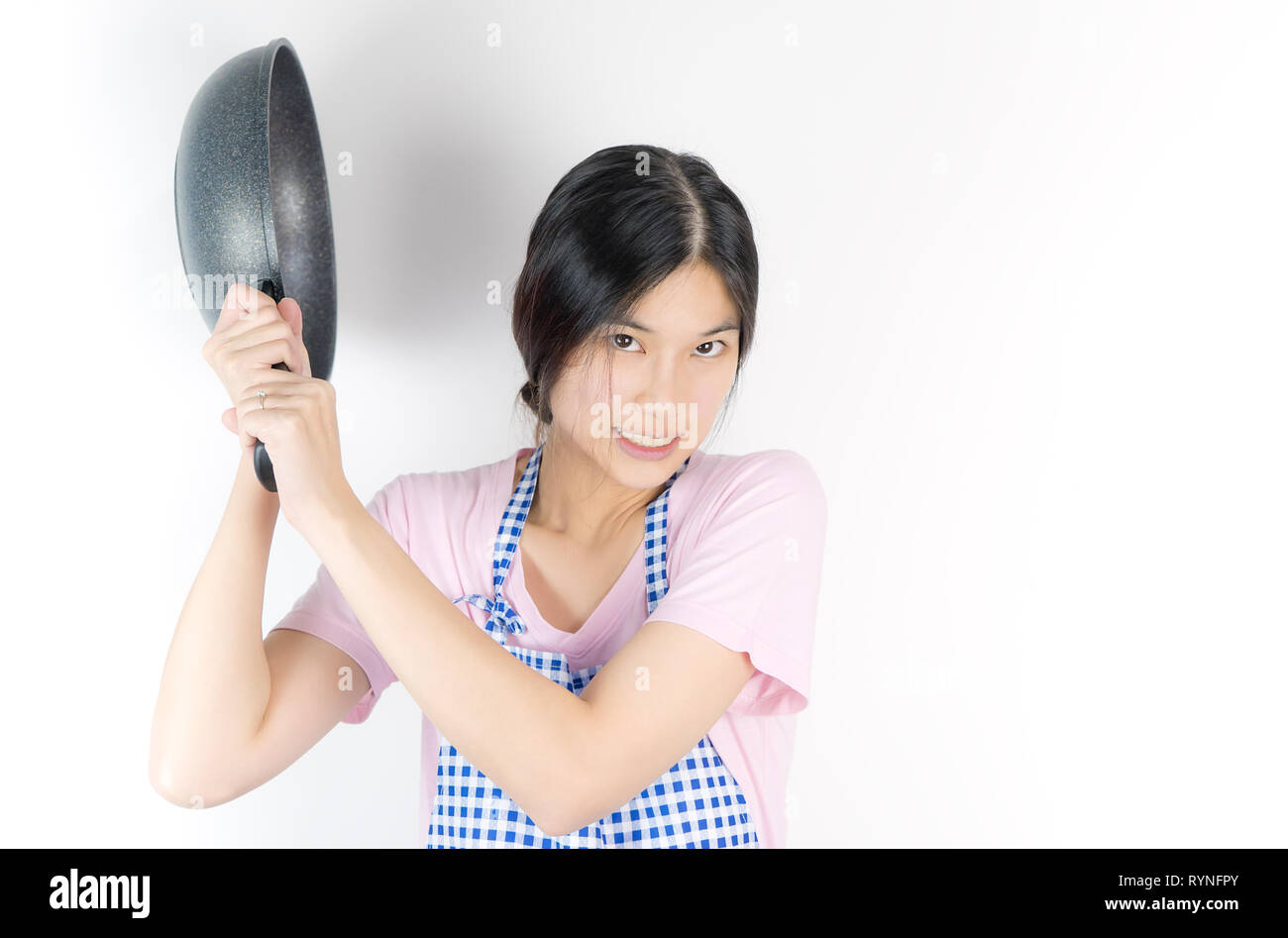 Angry House wife is ready to hit you with a pan Stock Photo