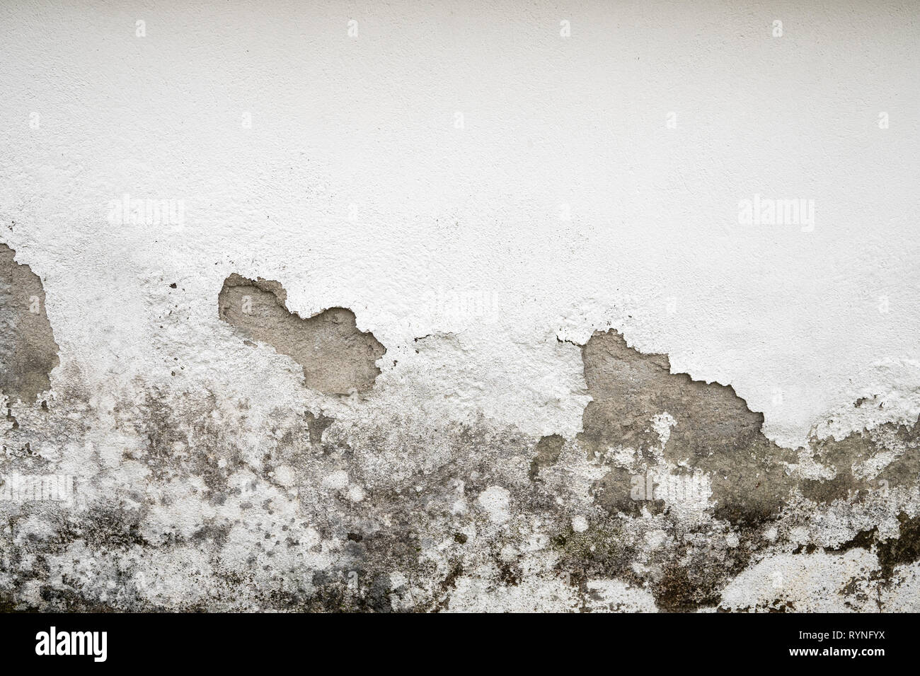 Concrete Painted Wall damaged by humidity Stock Photo
