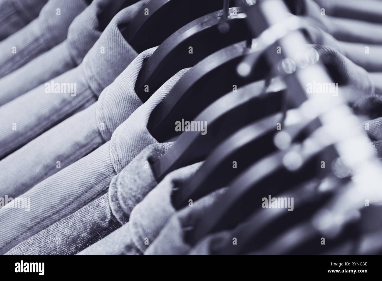 Row Of Denim Jackets Or Shirts On Black Hangers A Top View