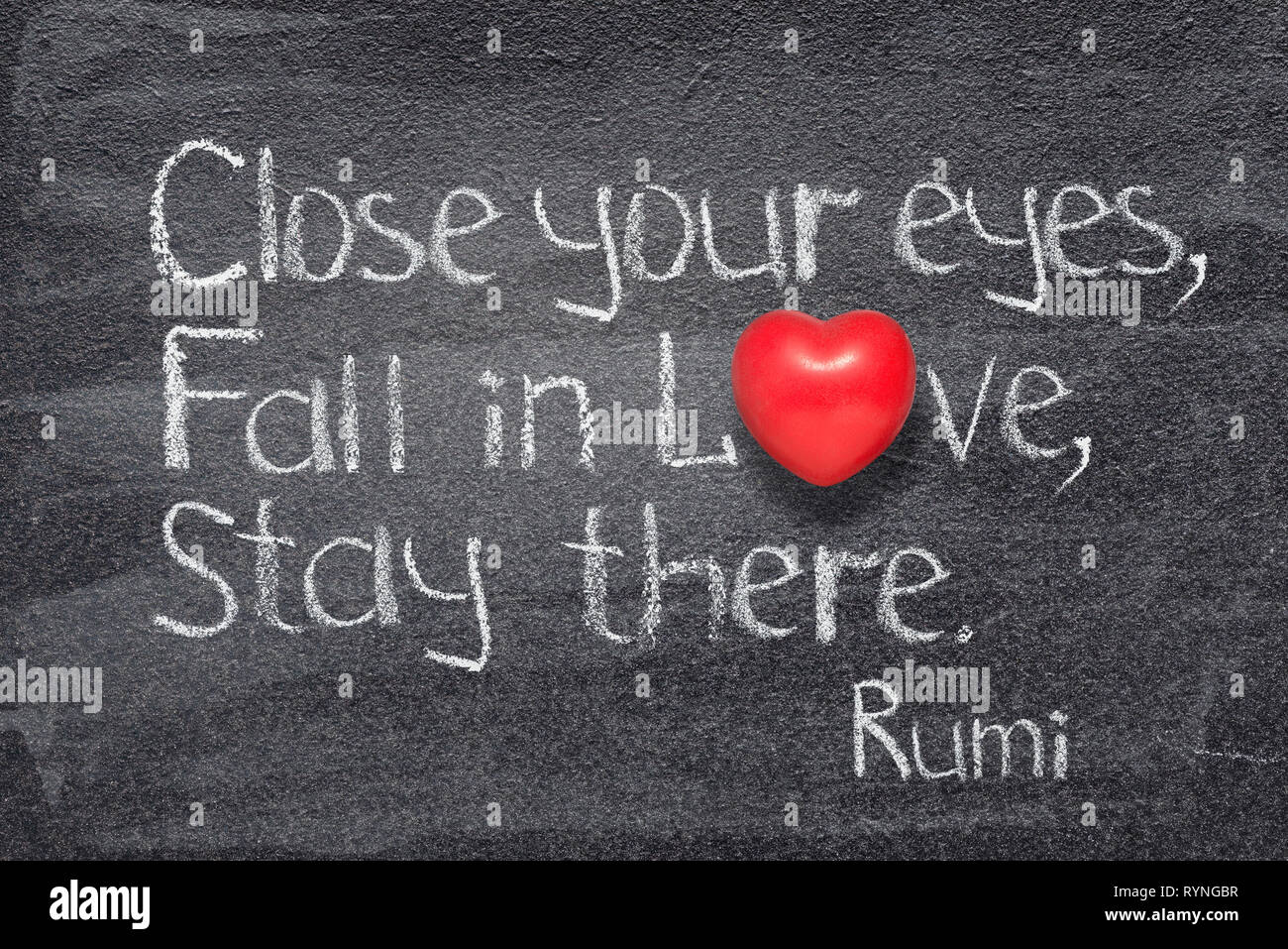 Close your eyes, fall in Love, stay there -  ancient Persian poet and philosopher Rumi quote written on chalkboard with red heart symbol instead of O Stock Photo