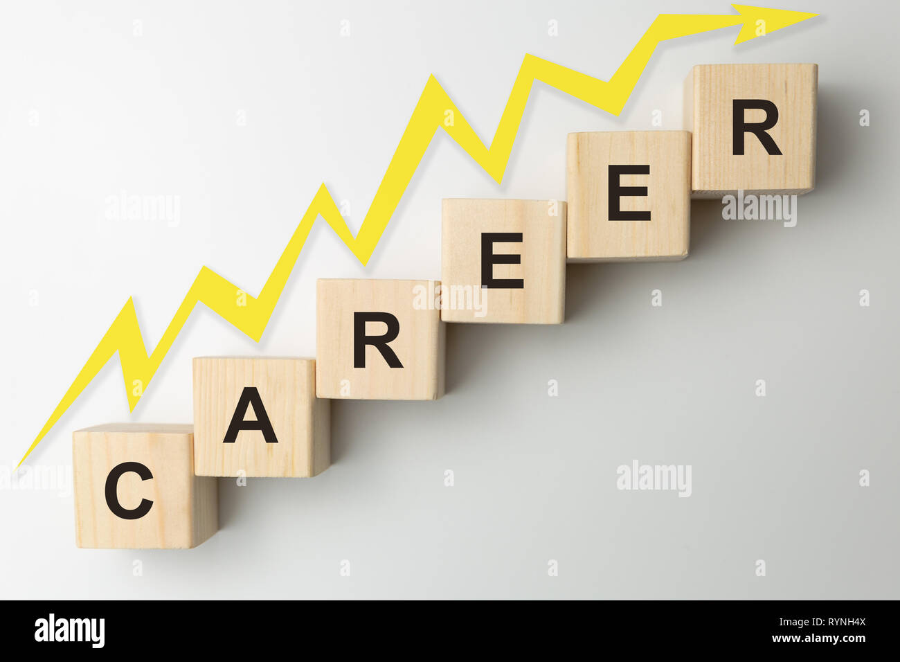 Wooden blocks arranged in stair shape with the word CAREER. Arrow pointing up Stock Photo