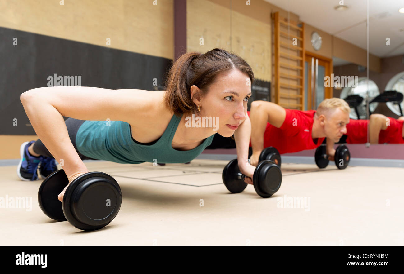 Fitness parners in sportswear doing exercises at gym. Fitness sport gym concept Stock Photo