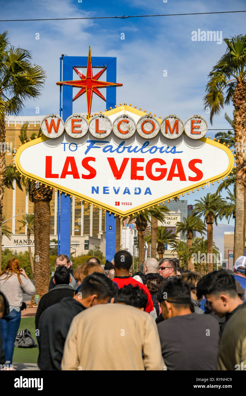 LAS VEGAS, NV, USA - FEBRUARY 2019: People queuing to have their picture taken in front of the famous 'Welcome to Las Vegas' sign. Stock Photo