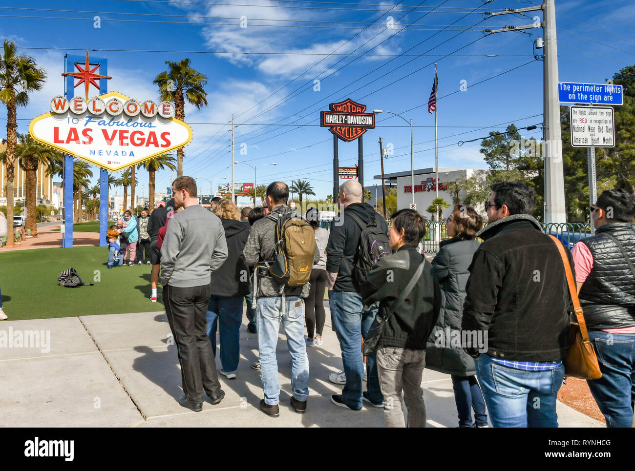 LAS VEGAS, NV, USA - FEBRUARY 2019: People queuing to have their picture taken in front of the famous 'Welcome to Las Vegas' sign. Stock Photo