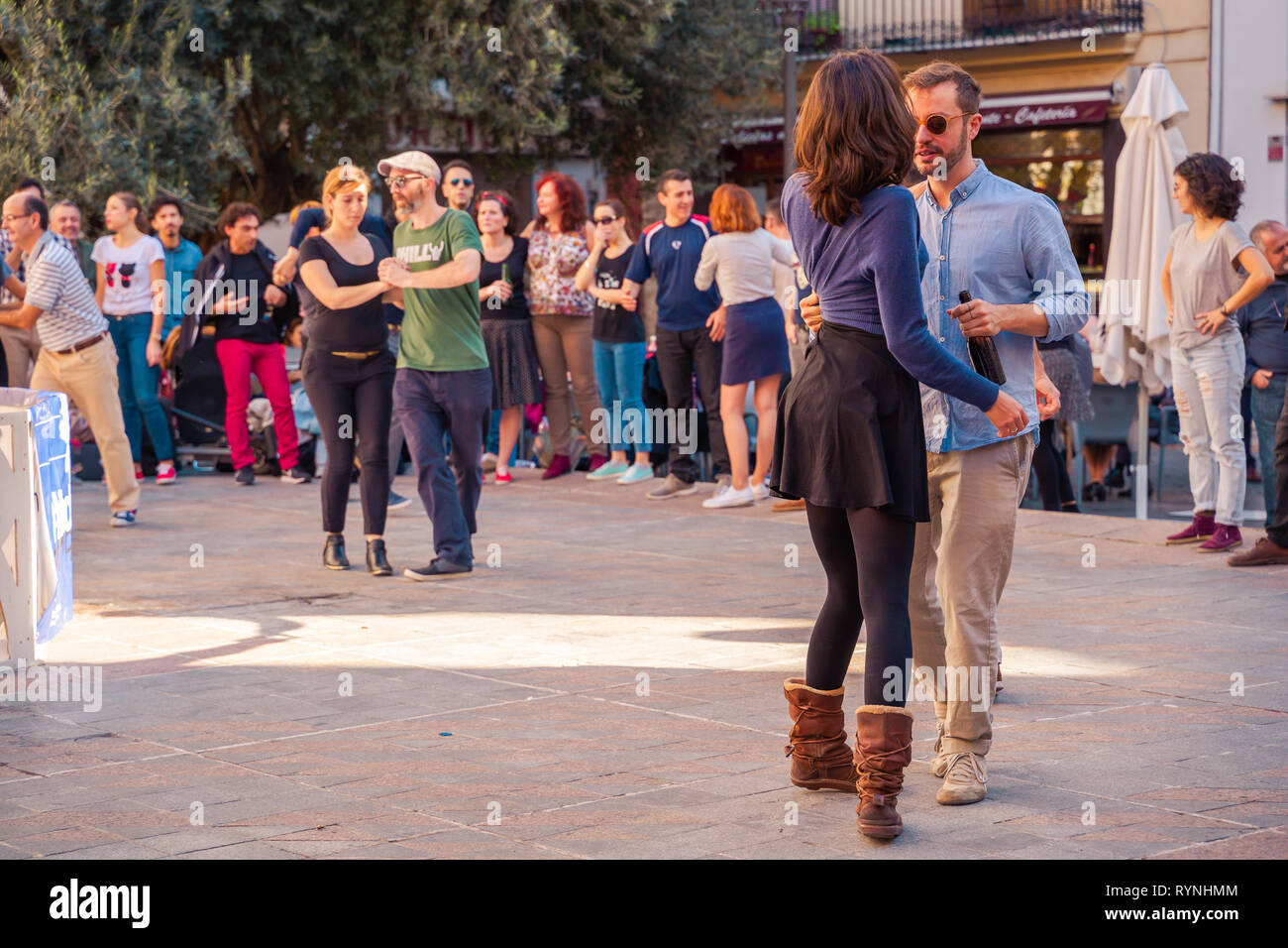 Valencia, Spain; December 2 2018: People dancing on the street during holiday. Young stylish couple dance. Having a good time. Stock Photo
